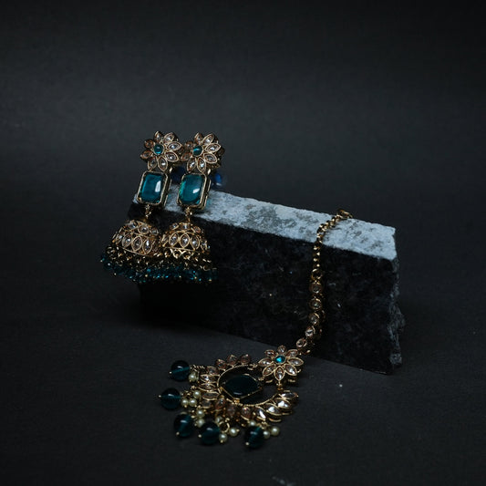 Jewelry set with earrings and necklace on a dark background